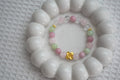 Crystal bracelet with pink, green, and gold beads on a white surface